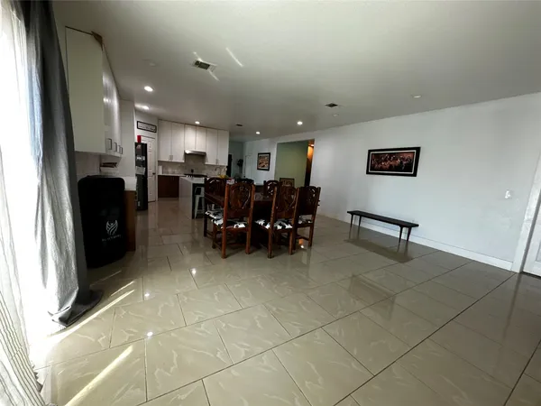 a view of a living room kitchen and dining area