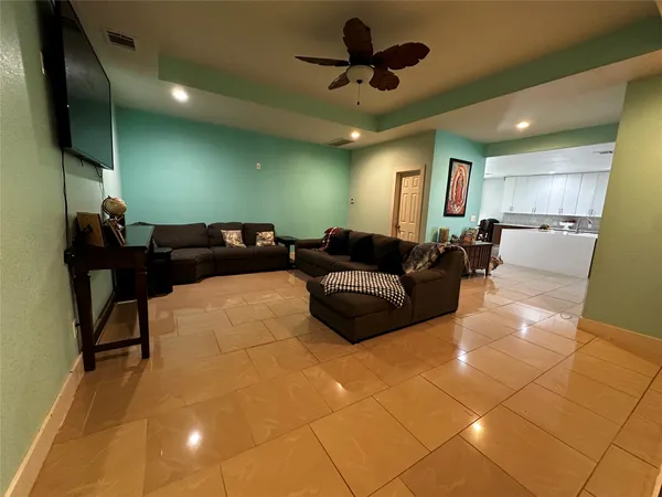 a living room with furniture and a chandelier