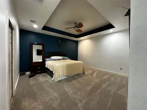a bedroom with a bed and a large mirror
