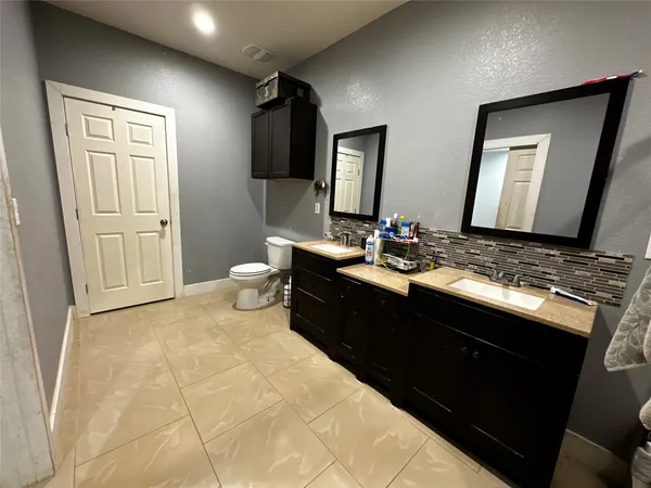 a bathroom with a double vanity sink and a mirror