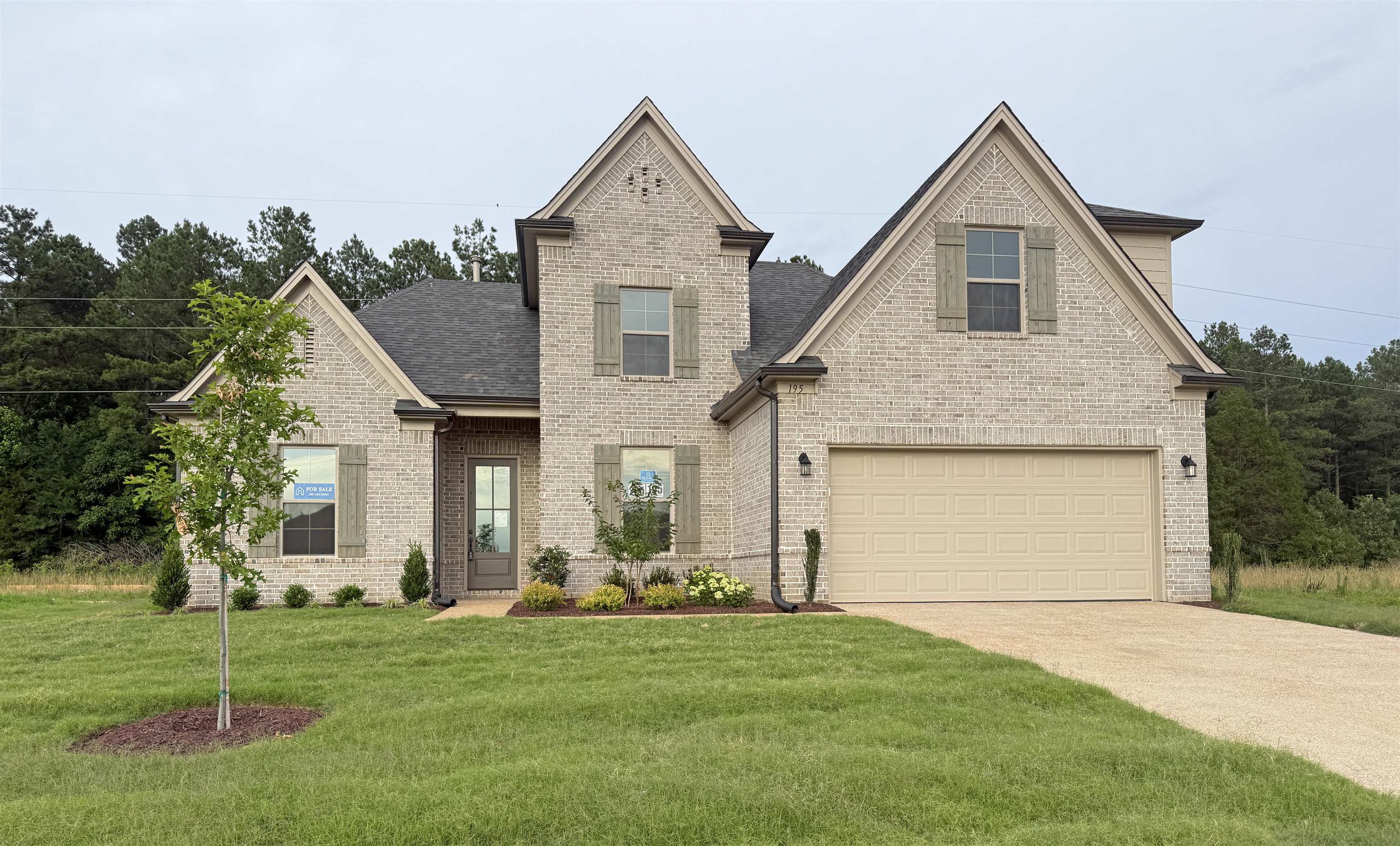 195 Ridgefield Drive Oakland, TN 38060 - Photo 1 of 29 a front view of a house with a garden and plants