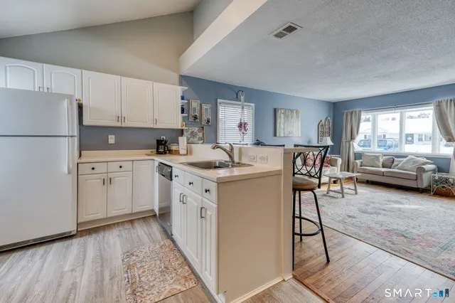 a bathroom with a toilet a sink a mirror and a shower curtain