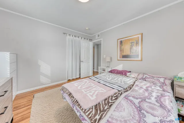 a view of a white house with a yard covered in snow