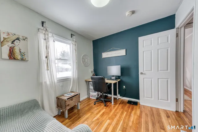 a street view covered with snow and covered with trees