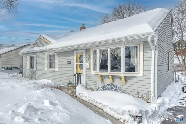 a front view of a house with a yard and seating space