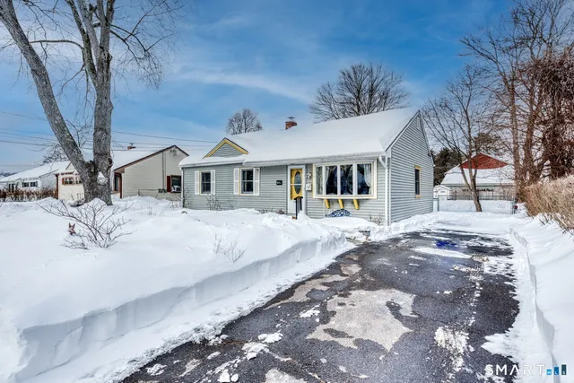 a view of a house with a wooden fence