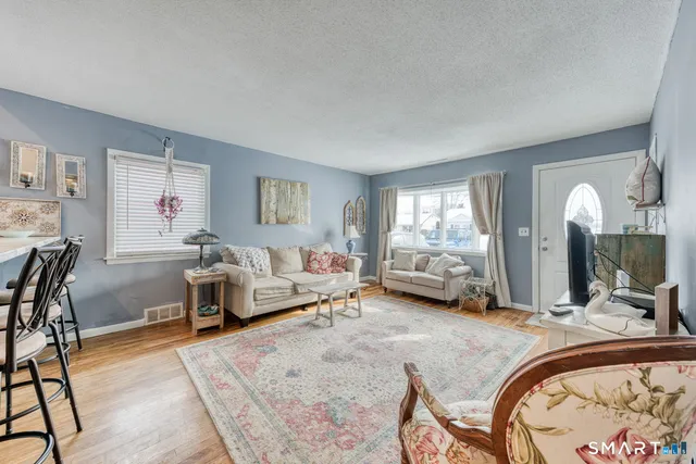 a bedroom with furniture and a flat screen tv