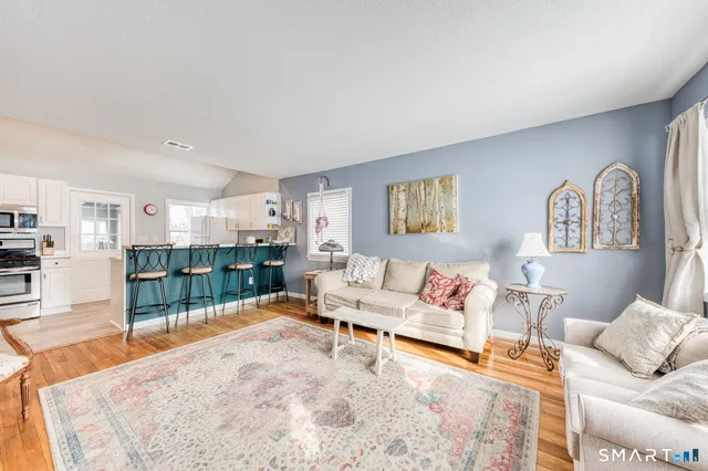 a kitchen with granite countertop white cabinets and stainless steel appliances