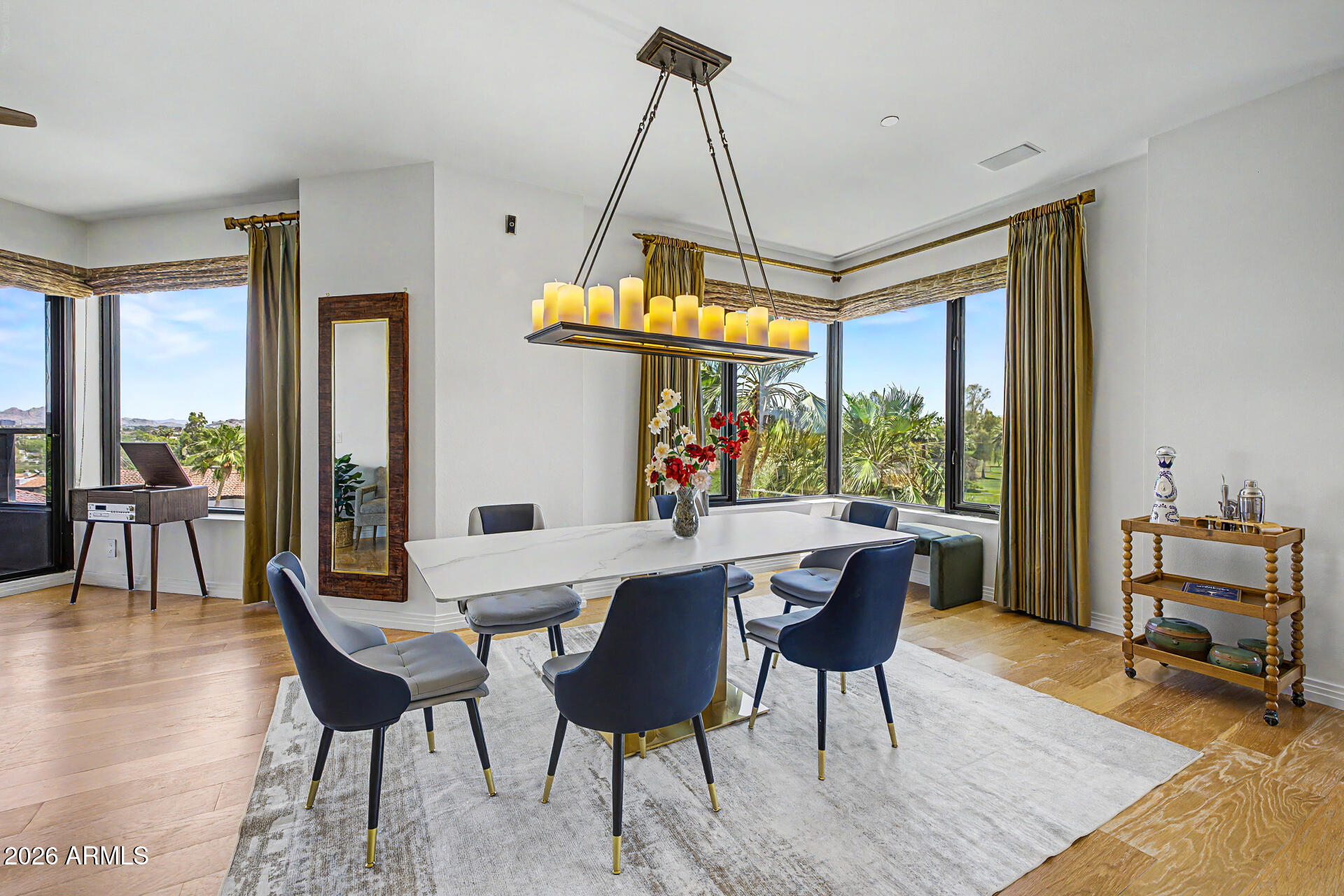 1040 East Osborn Road, Unit 402 Phoenix, AZ 85014 - Photo 21 of 96 a dining room with furniture a chandelier and wooden floor