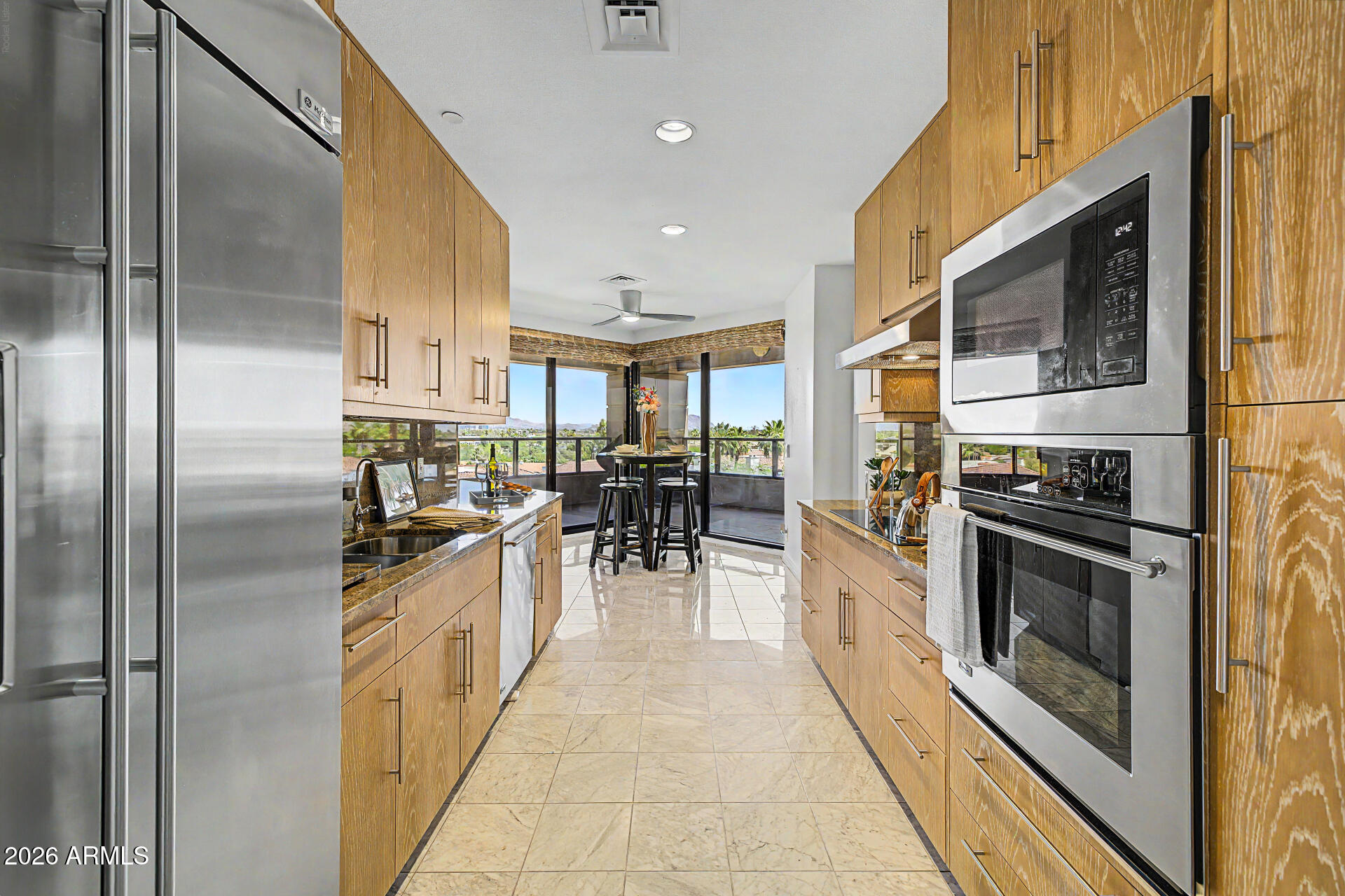 1040 East Osborn Road, Unit 402 Phoenix, AZ 85014 - Photo 31 of 96 a kitchen with stainless steel appliances granite countertop a stove a sink and a refrigerator