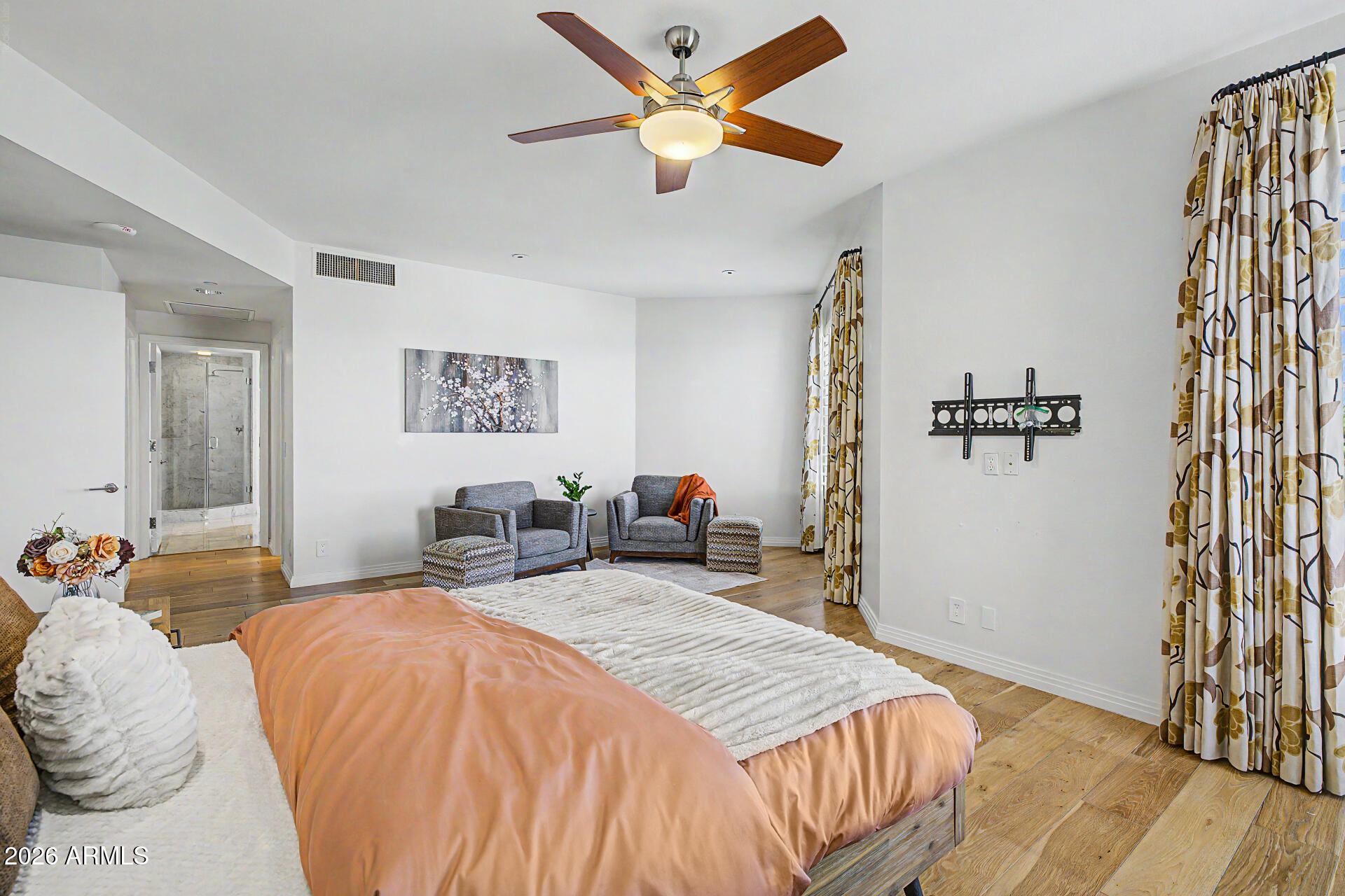 1040 East Osborn Road, Unit 402 Phoenix, AZ 85014 - Photo 42 of 96 a bedroom with a bed and a chandelier