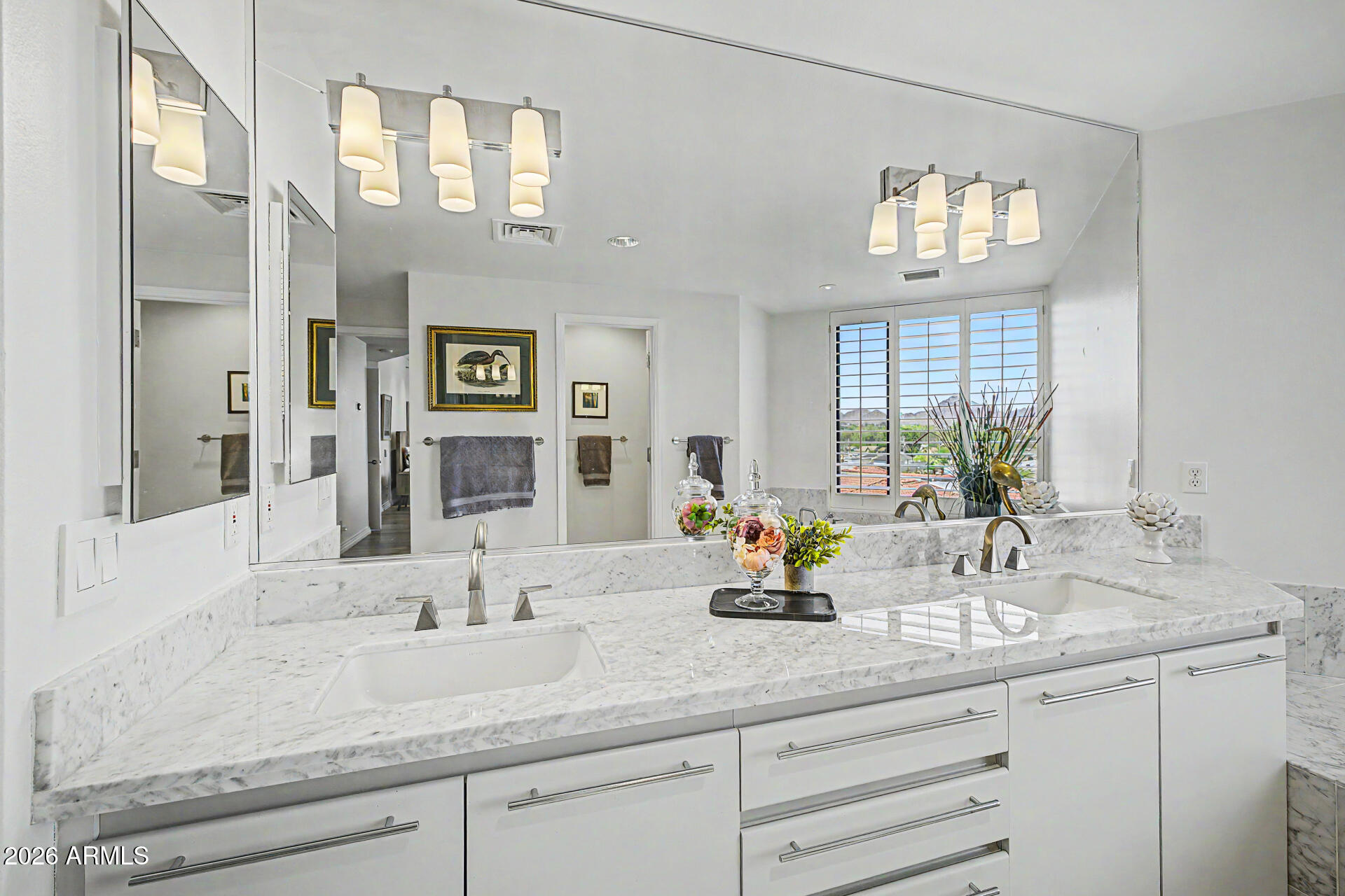 1040 East Osborn Road, Unit 402 Phoenix, AZ 85014 - Photo 45 of 96 a bathroom with double vanity sinks a mirror and a window