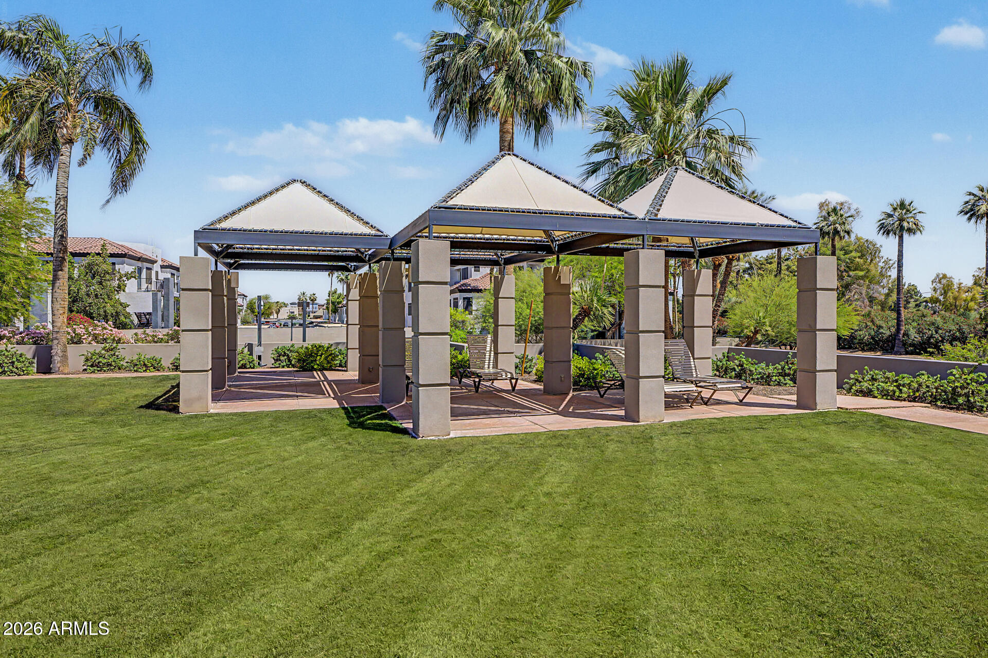 1040 East Osborn Road, Unit 402 Phoenix, AZ 85014 - Photo 78 of 96 a front view of a house with swimming pool and porch with furniture