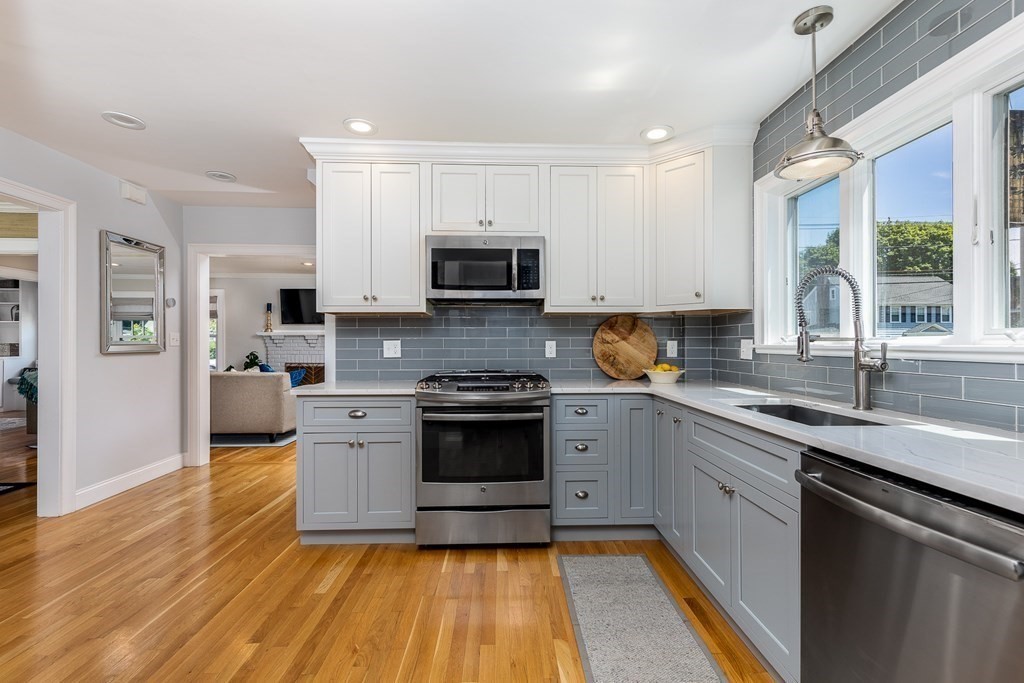 8 Pickwick Road Marblehead, MA 01945 - Photo 13 of 35 a kitchen with stainless steel appliances granite countertop a stove a sink and a microwave