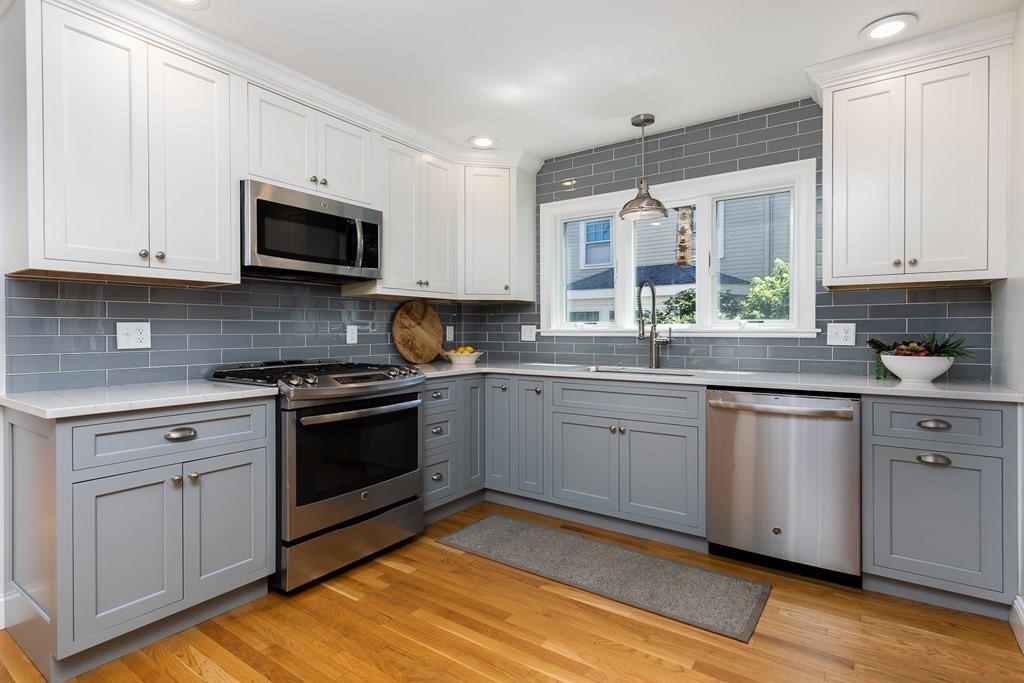 8 Pickwick Road Marblehead, MA 01945 - Photo 14 of 35 a kitchen with stainless steel appliances granite countertop a stove a sink and white cabinets