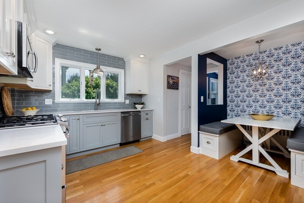 8 Pickwick Road Marblehead, MA 01945 - Photo 15 of 35 a kitchen with stainless steel appliances kitchen island granite countertop a stove a sink dishwasher and a microwave with wooden floor