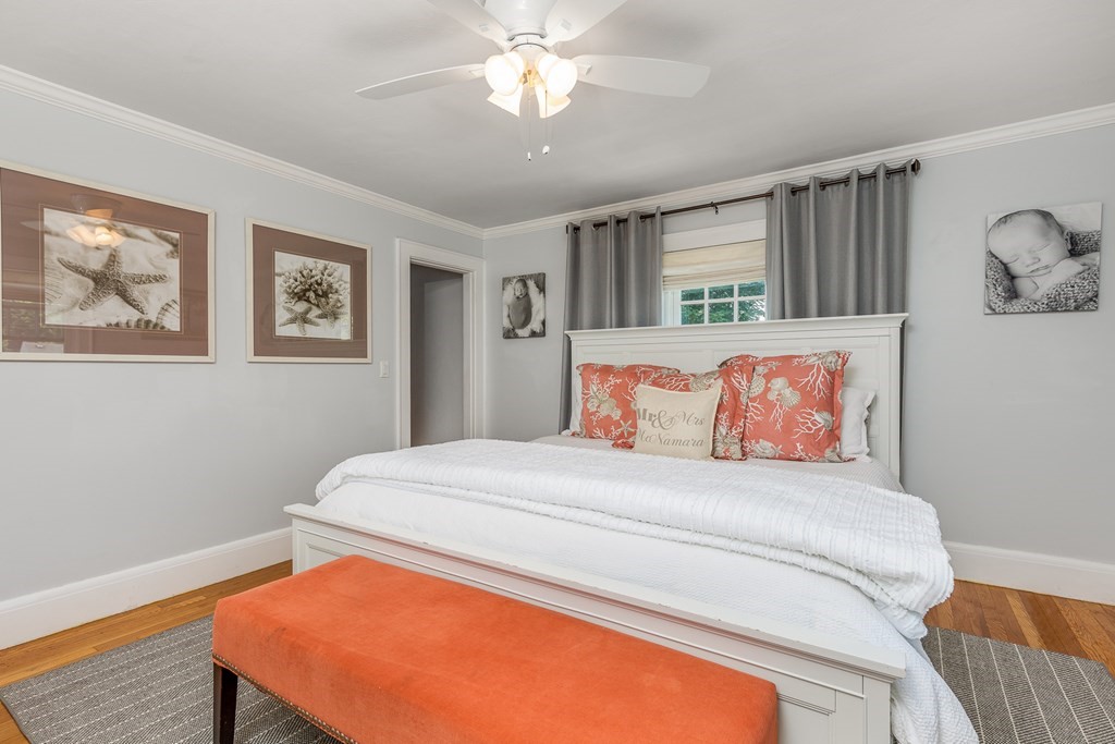 8 Pickwick Road Marblehead, MA 01945 - Photo 20 of 35 a bedroom with a bed and a chandelier