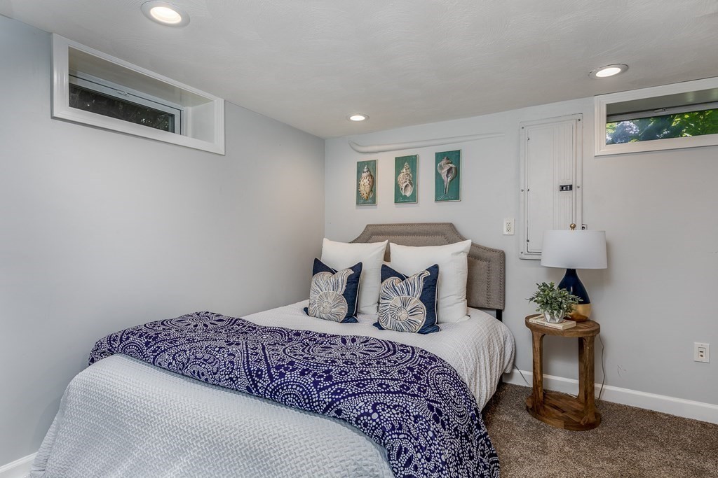 8 Pickwick Road Marblehead, MA 01945 - Photo 27 of 35 a bedroom with a bed and a potted plant