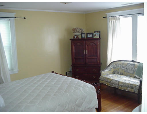 66 Robbins Road Watertown, MA 02472 - Photo 11 of 16 a bedroom with a bed and wooden floor