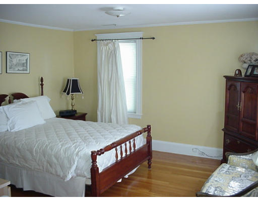 66 Robbins Road Watertown, MA 02472 - Photo 10 of 16 a bedroom with a bed and wooden floor