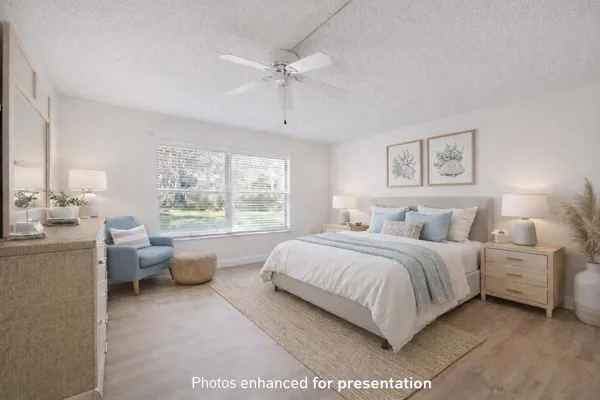 a spacious bedroom with a bed and a chandelier