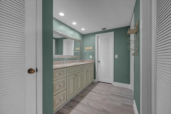 a bathroom with a granite countertop sink a mirror and a shower