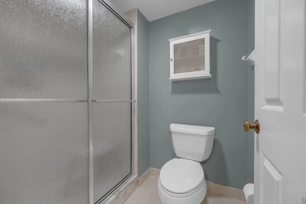 a white toilet sitting next to a bathroom sink