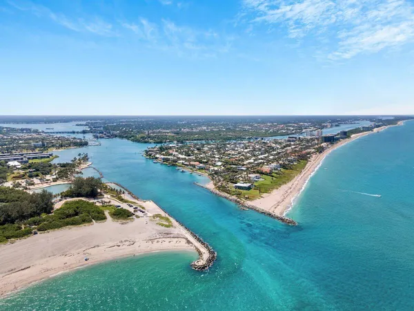an aerial view of a residential houses with outdoor space and ocean view