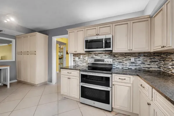 a kitchen with cabinets stainless steel appliances and a counter space