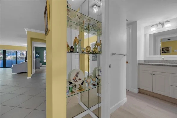 a view of a hallway with dining area and chandelier