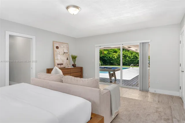 a bedroom with a large bed and a large window