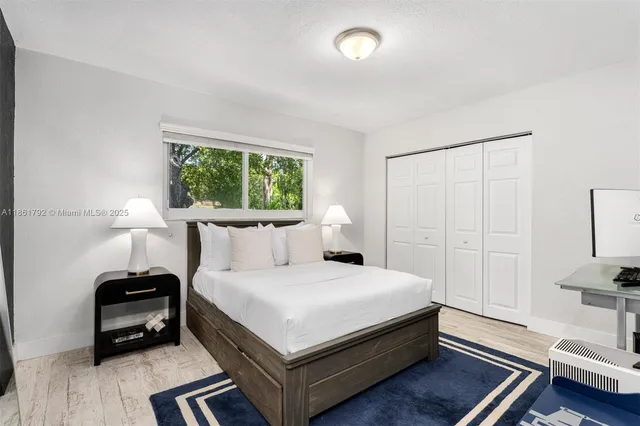 a bedroom with a bed table and a window