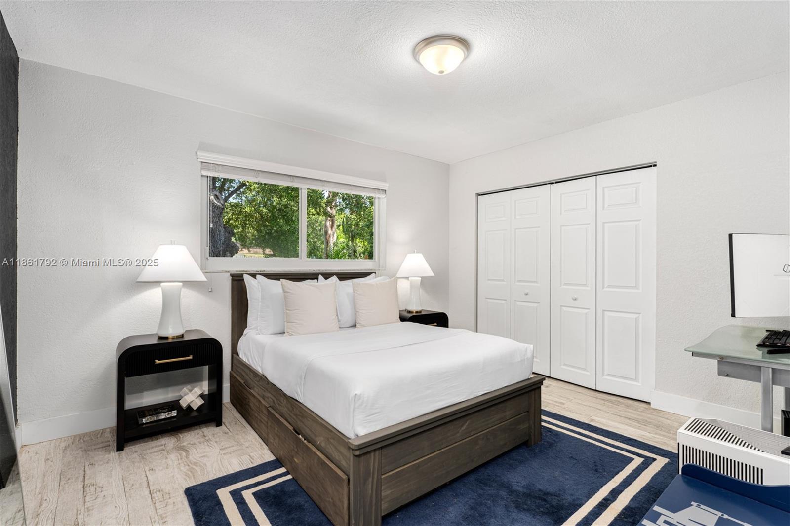 5940 Southwest 120th Street Pinecrest, FL 33156 - Photo 21 of 40 a bedroom with a bed table and a window