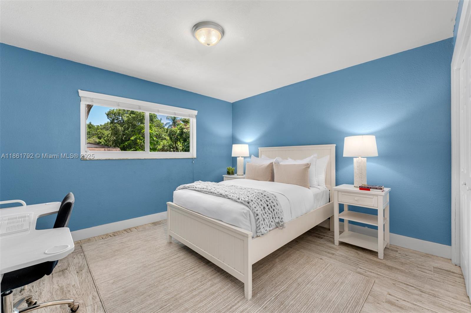 5940 Southwest 120th Street Pinecrest, FL 33156 - Photo 22 of 40 a bedroom with a bed and a lamp