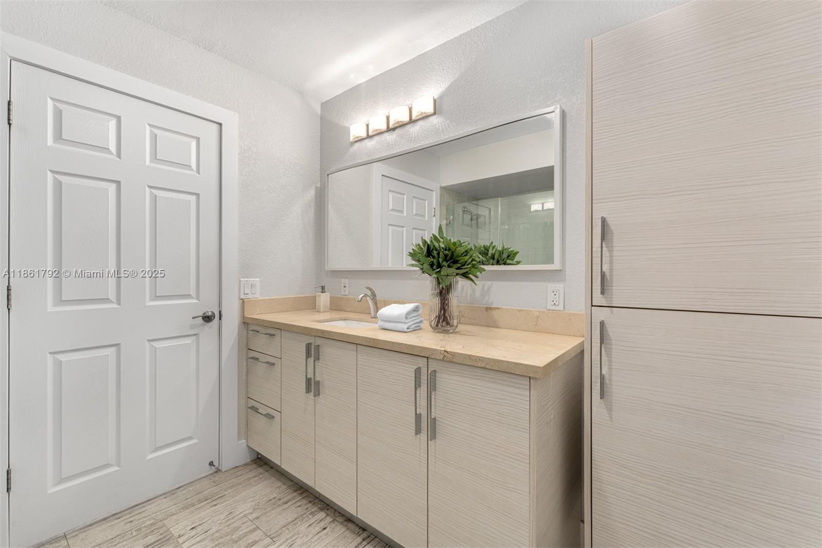 5940 Southwest 120th Street Pinecrest, FL 33156 - Photo 23 of 40 a bathroom with a sink and a mirror