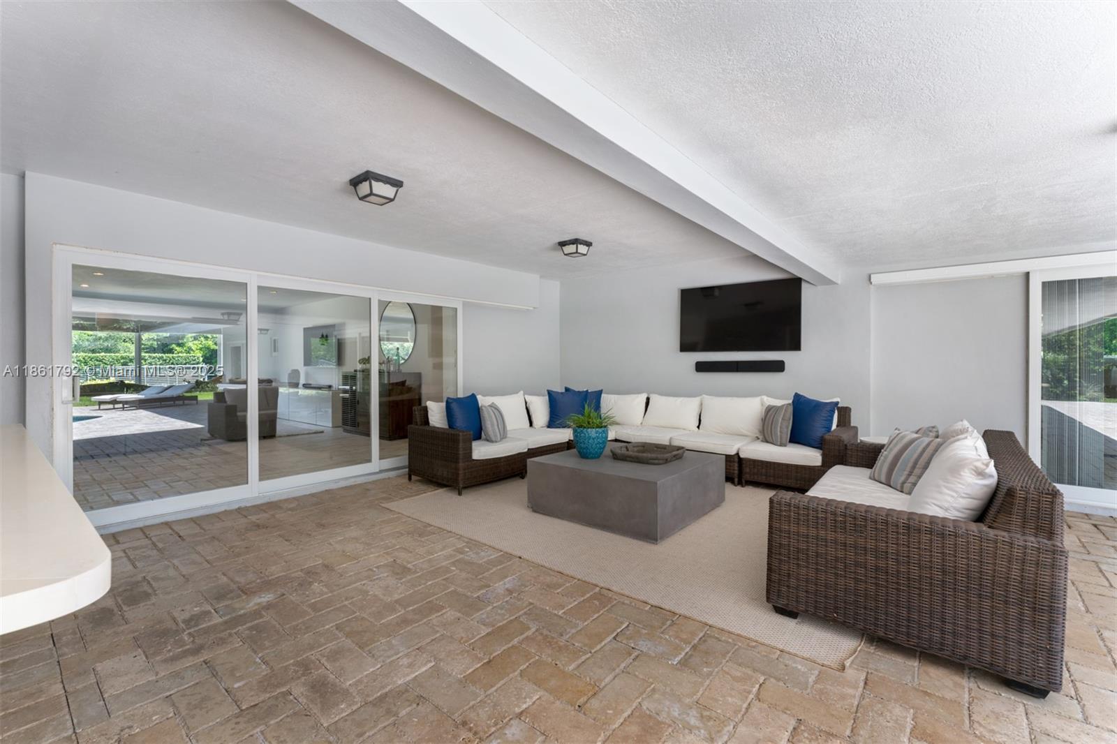 5940 Southwest 120th Street Pinecrest, FL 33156 - Photo 25 of 40 a living room with furniture and a flat screen tv
