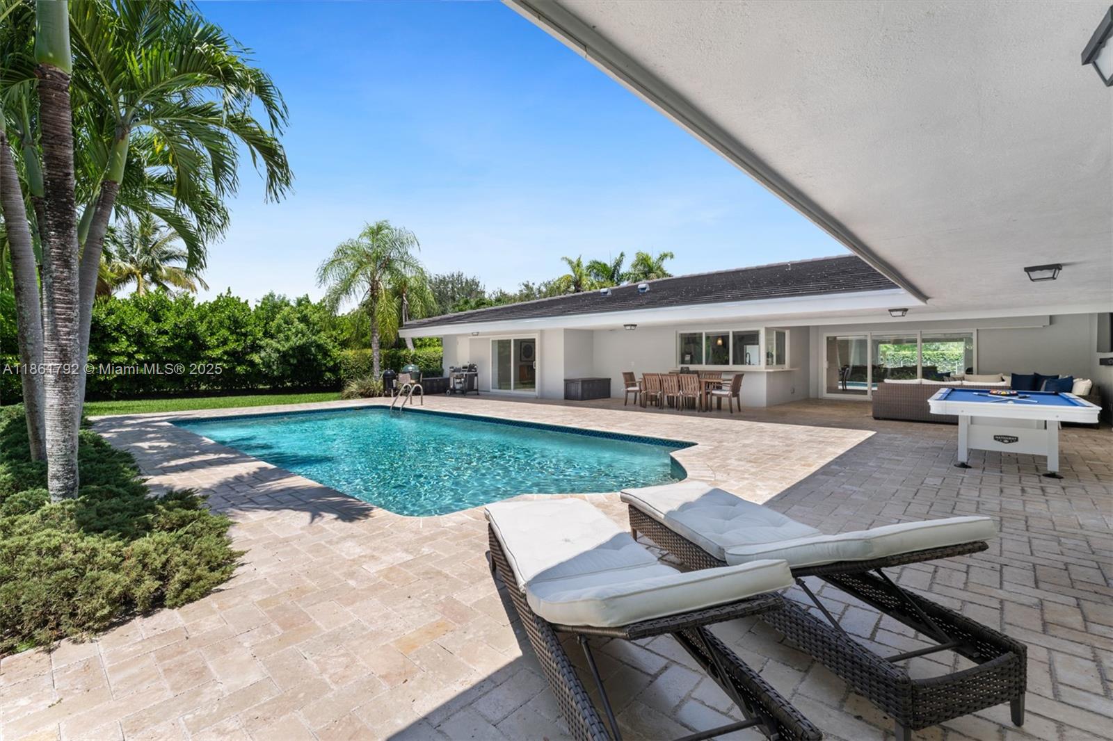 5940 Southwest 120th Street Pinecrest, FL 33156 - Photo 30 of 40 a view of a house with swimming pool and sitting area