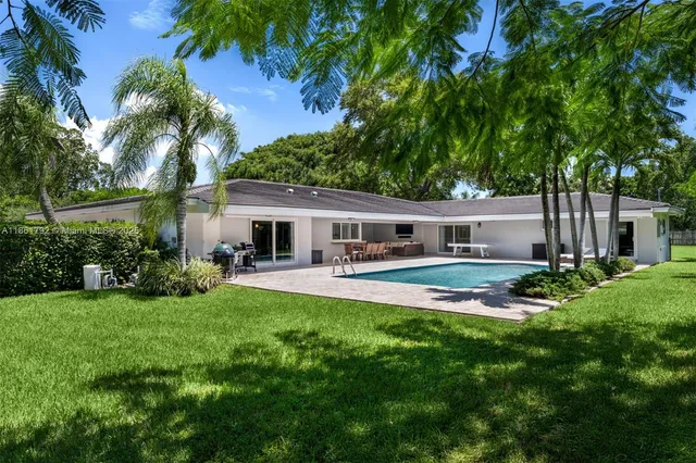 a front view of house with yard and green space
