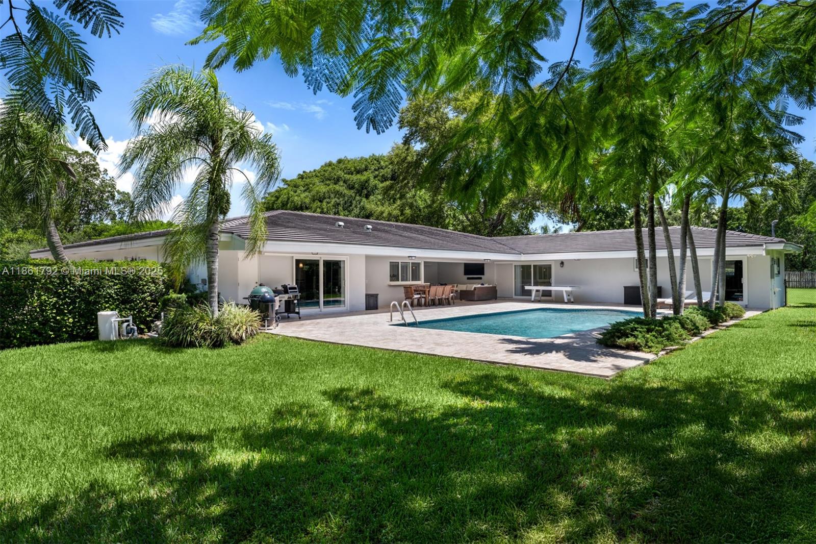 5940 Southwest 120th Street Pinecrest, FL 33156 - Photo 32 of 40 a front view of house with yard and green space