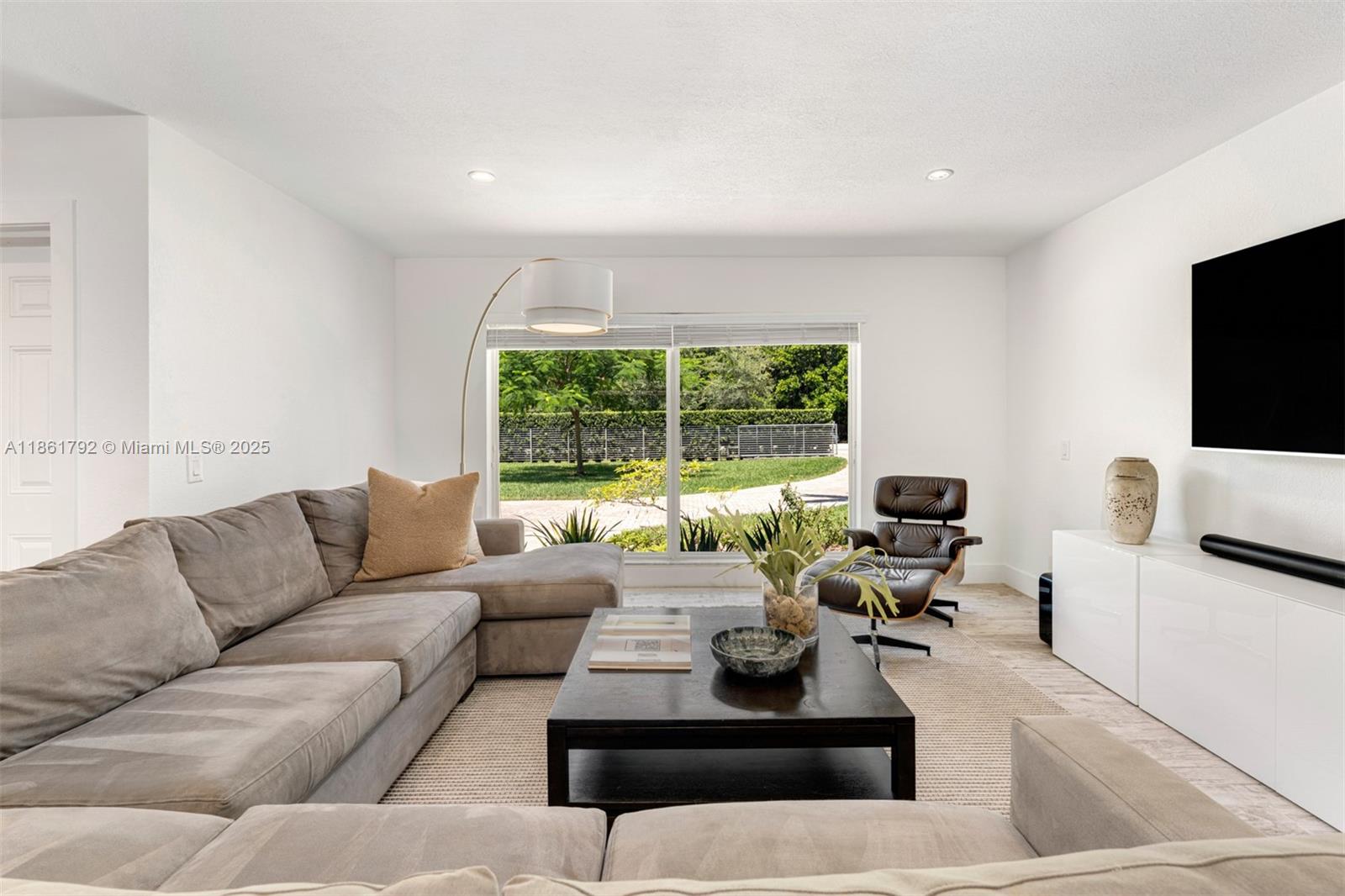 5940 Southwest 120th Street Pinecrest, FL 33156 - Photo 6 of 40 a living room with furniture and a flat screen tv
