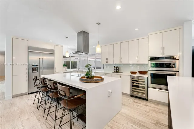 a kitchen with stainless steel appliances kitchen island granite countertop a sink and cabinets