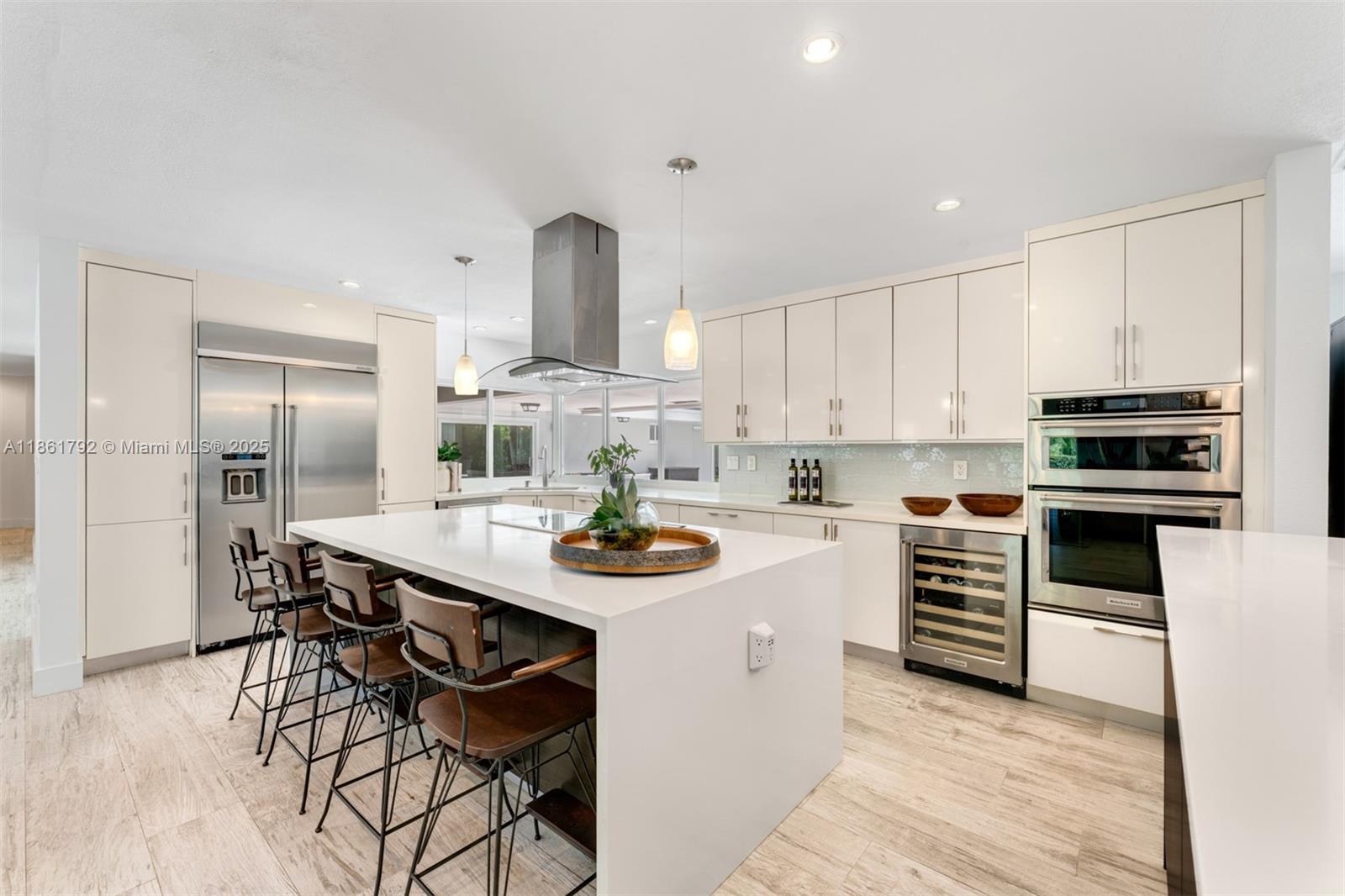 5940 Southwest 120th Street Pinecrest, FL 33156 - Photo 8 of 40 a kitchen with stainless steel appliances kitchen island granite countertop a sink and cabinets