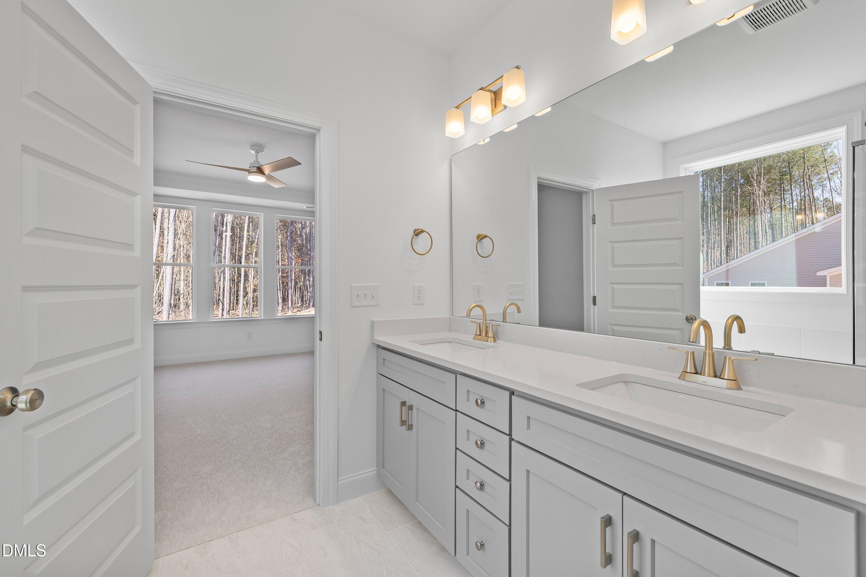 62 West Victoria Ridge Drive, Unit 19 Selma, NC 27576 - Photo 16 of 26 a en suite bathroom with a sink and a mirror