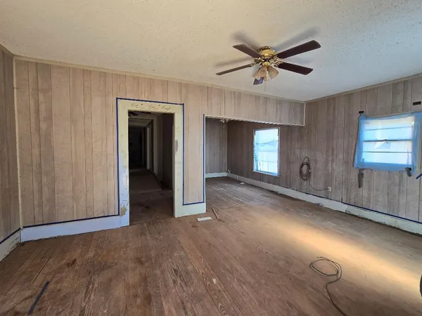 a view of a livingroom with a ceiling fan and window