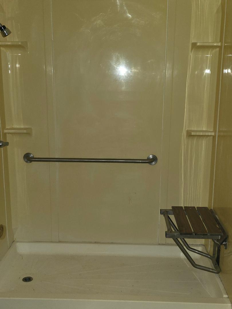 1506 North 1st Street Lamesa, TX 79331 - Photo 4 of 10 a bathroom with a shower and a bath tub