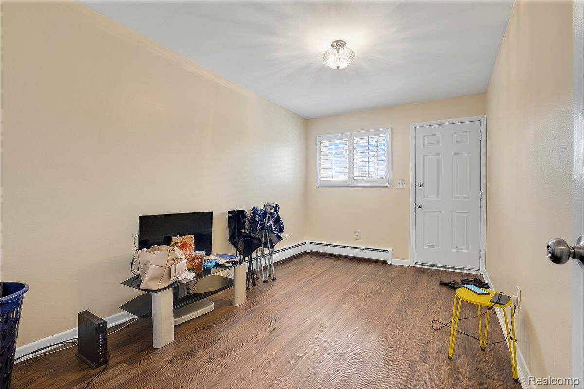 22444 Kelly Road, Unit 11 Eastpointe, MI 48021 - Photo 9 of 13 Miscellaneous room with dark wood-style flooring and baseboard heating