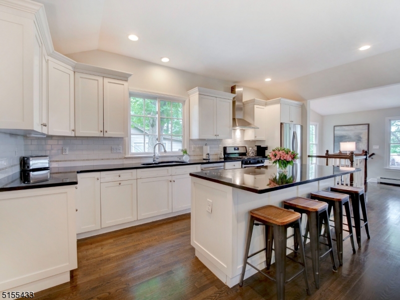 33 Cliffside Trail Denville, NJ 07834 - Photo 5 of 25 a kitchen with granite countertop white cabinets and chairs