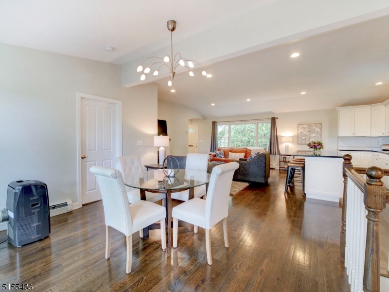 33 Cliffside Trail Denville, NJ 07834 - Photo 9 of 25 a view of a dining room and livingroom with furniture wooden floor a chandelier