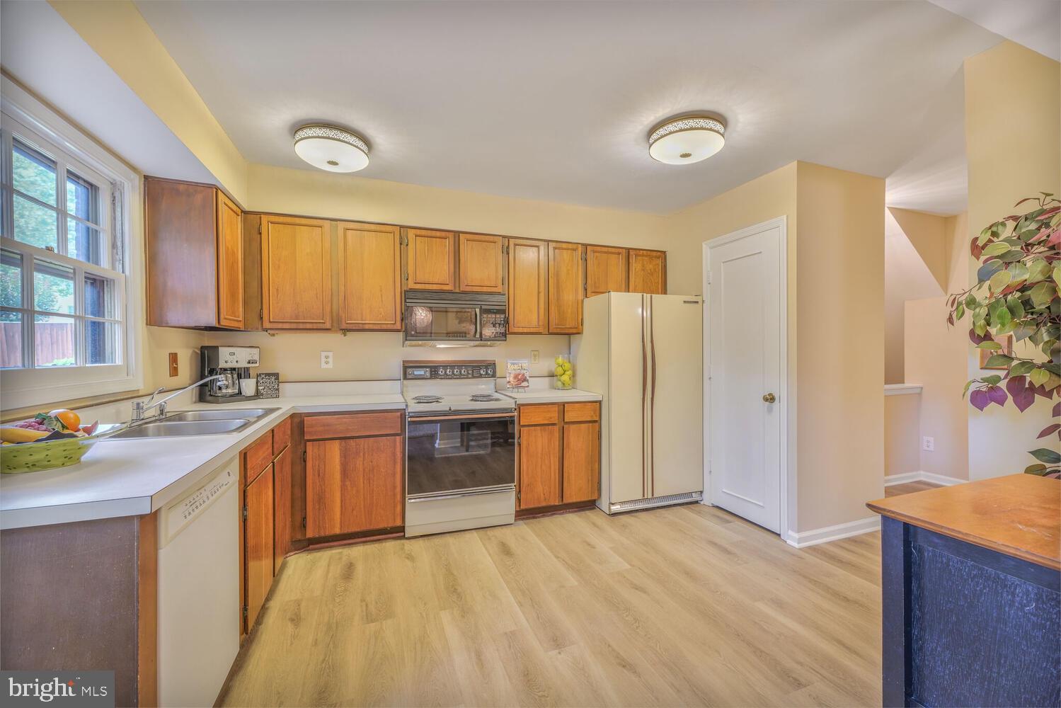 5932 Queenston Street Springfield, VA 22152 - Photo 14 of 47 a kitchen with stainless steel appliances granite countertop a refrigerator stove and sink