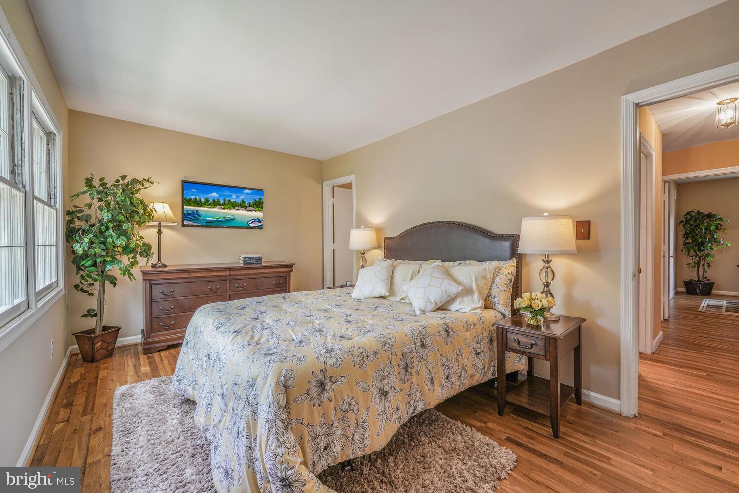 5932 Queenston Street Springfield, VA 22152 - Photo 17 of 47 a bedroom with a bed table and a painting